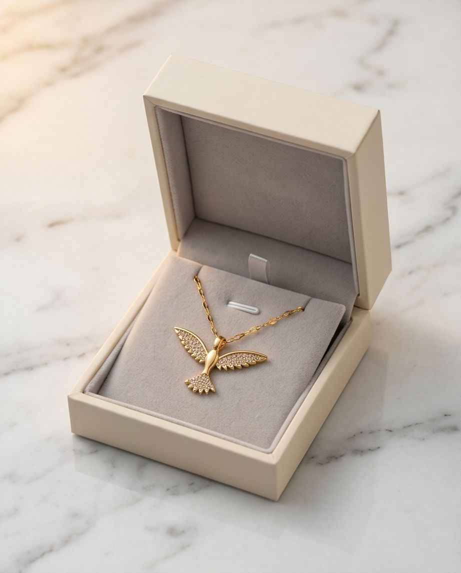 Gold bird necklace with butterfly-style pendant and fine-link chain