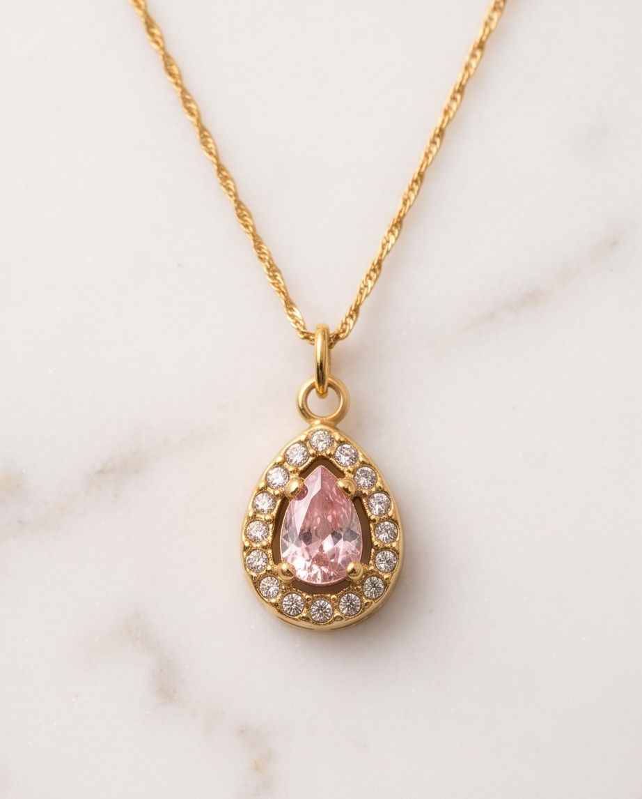 Gold chain teardrop pendant with pink gemstone center and sparkling halo stones