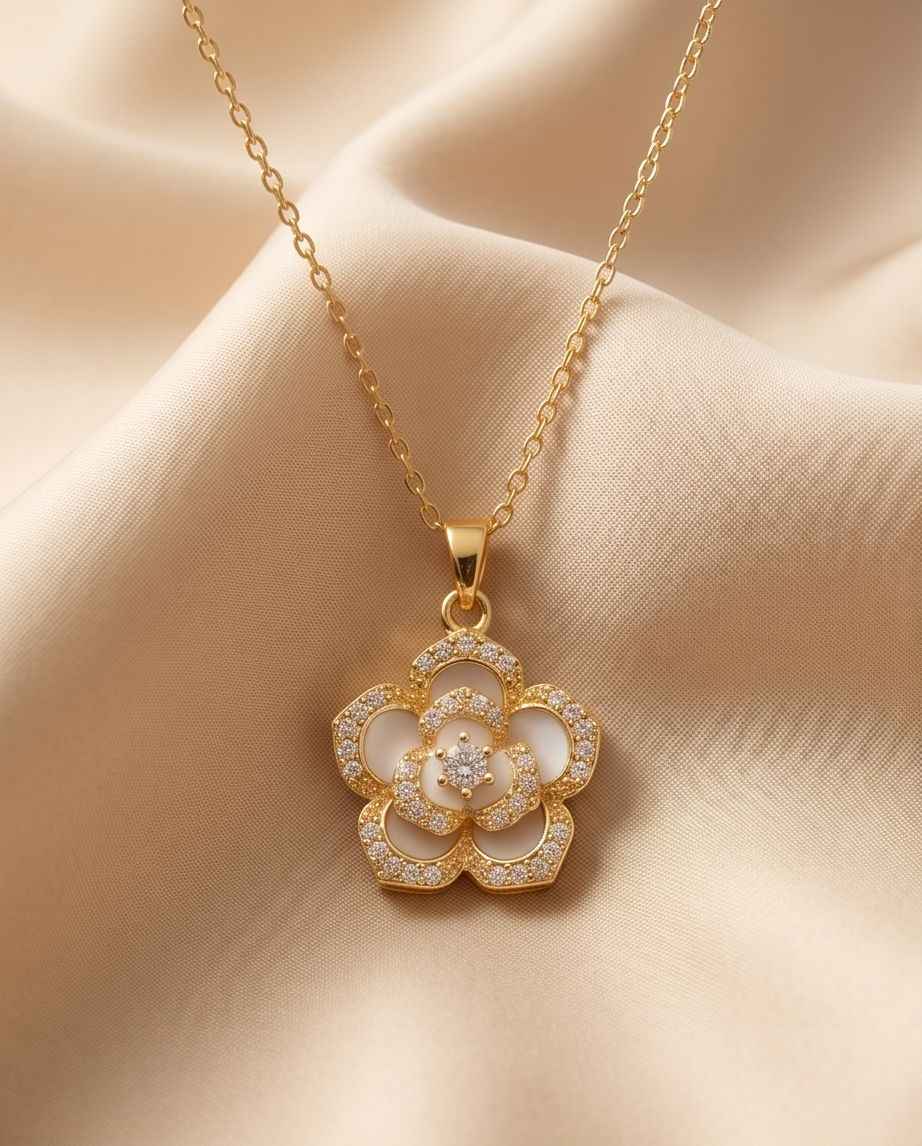Gold chain pendant with five-petal floral design and diamond-like center