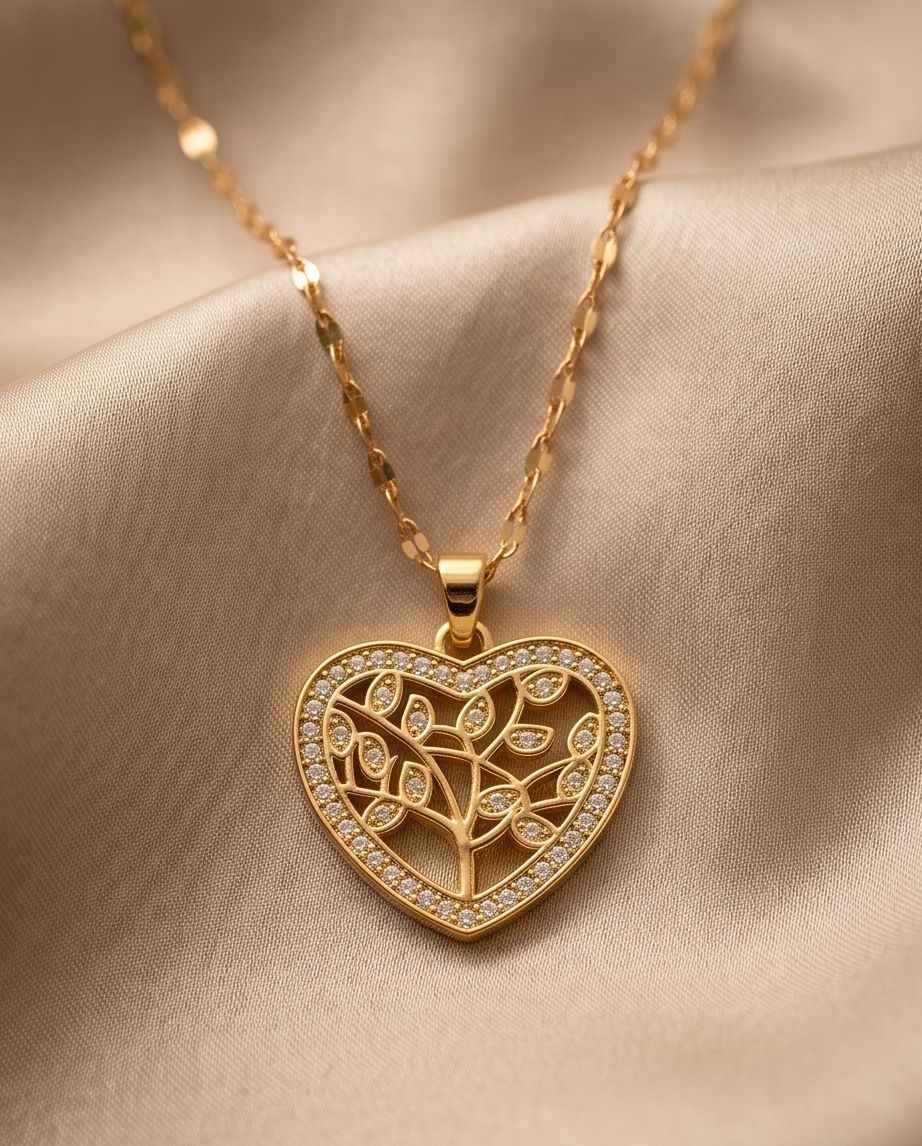 Gold heart pendant necklace with tree-of-life heart and crystal border on chain