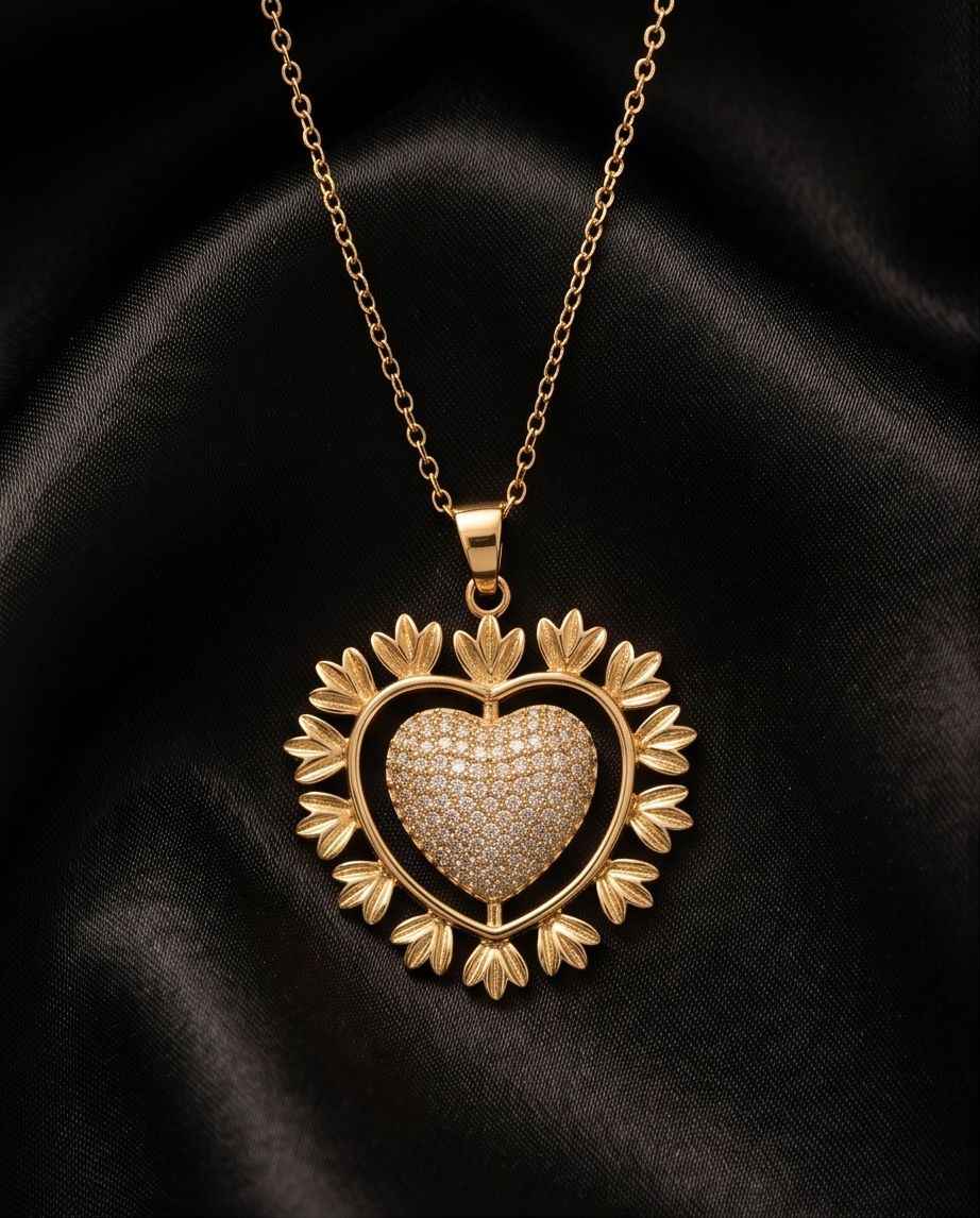 Gold heart pavé pendant with leaf-like accents on a thin chain necklace