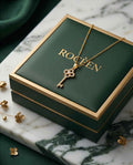 Gold key pendant necklace with clover design and round clear stones on chain
