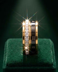 Gold-tone trinity ring with gemstone rows and Roman numeral inlay