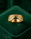 Gold angel wings ring with open top and engraved wing details