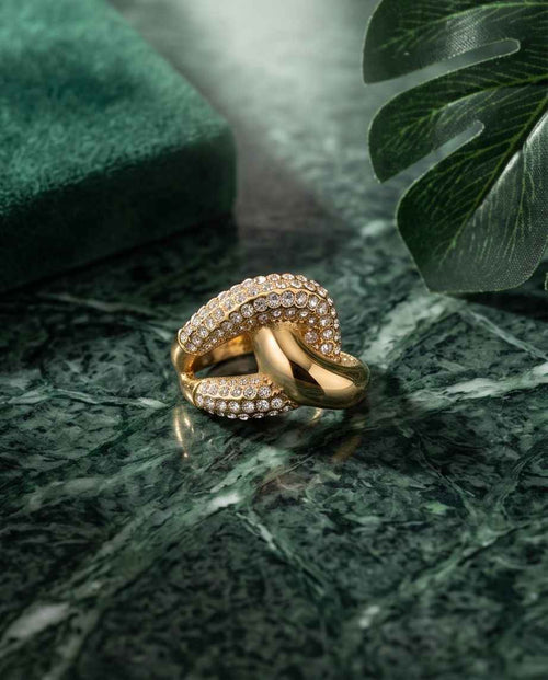 Gold-tone crossover ring with pavé set clear stones in curved double band