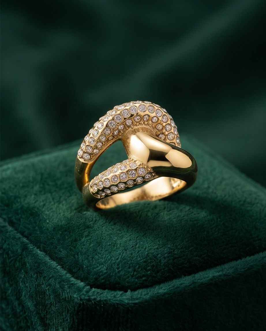 Gold-tone abstract pavé crossover ring with clear stones, front view on stand