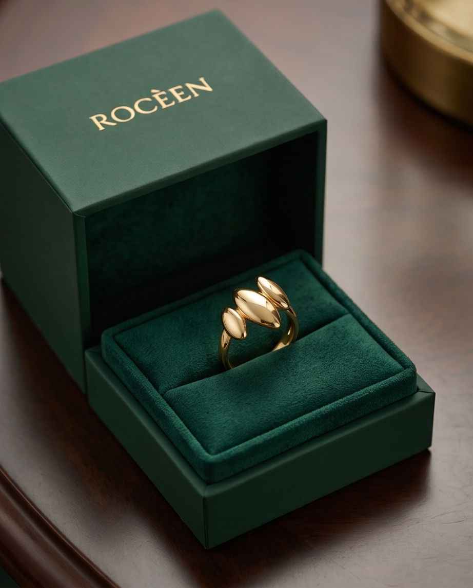 Aurelia triple-form gold ring in a box with three polished oval bands