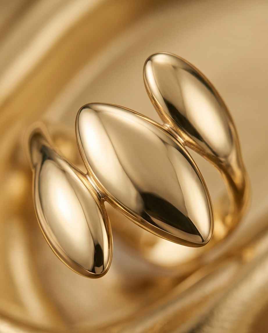 Gold triple-form ring close-up with three mirrored oval bands