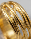 Gold statement ring with intertwined openwork bands and polished finish