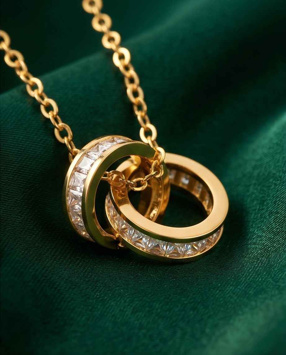 Gold-tone ring pendant with clear crystal insets on a link chain