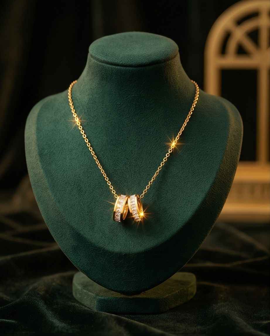 Gold-tone chain necklace with interlinked ring pendant set with clear stones