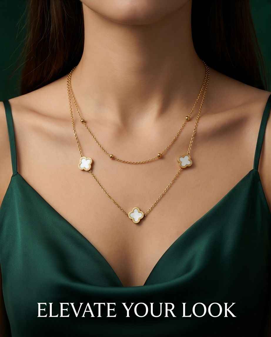 Gold clover mother-of-pearl necklace worn with three clover charms