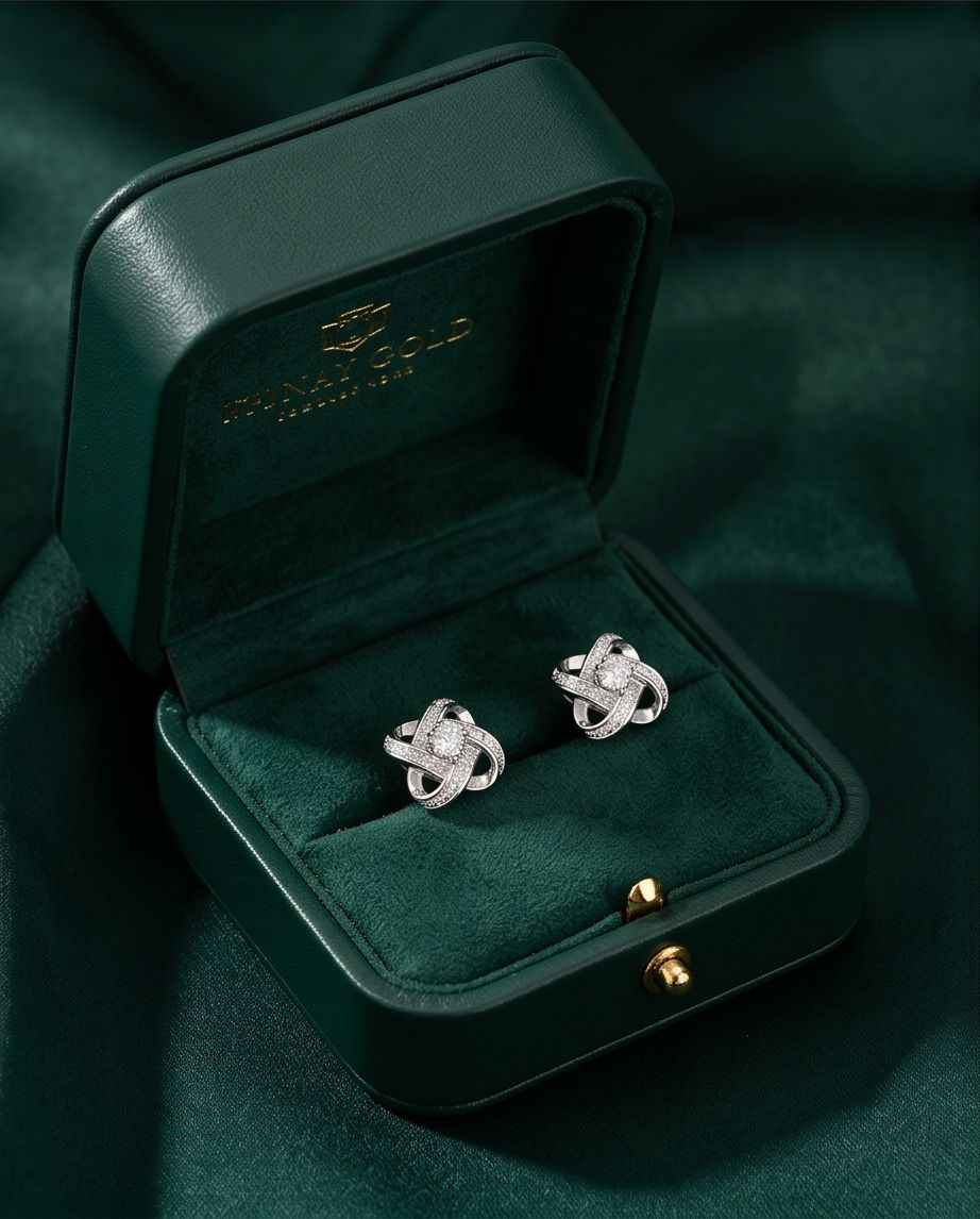 Sterling silver knot stud earrings with pavé detailing and round center stones, pair