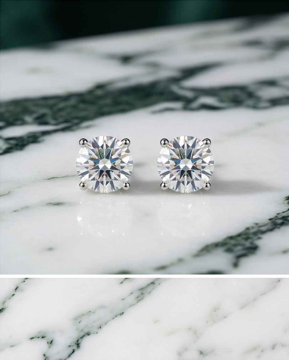 Pair of 925 sterling solitaire stud earrings with round clear stones and silver prongs