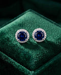 Sapphire halo stud earrings with round blue center stone and crystal border