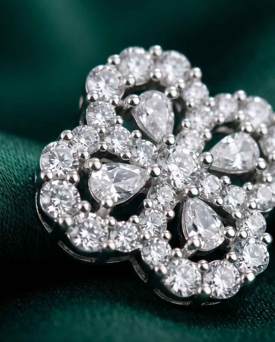 Close-up of flower diamond stud earrings with pavé halo and round crystal stones