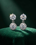 Silver halo drop earrings with round clear stones and dangling pavé accents