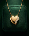 Gold heart pendant necklace with pavé stones on the heart edge, on a link chain