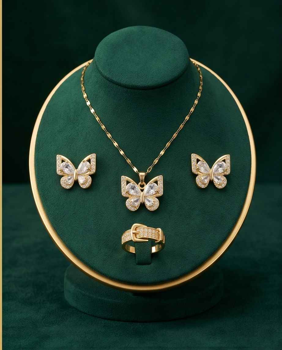 Gold-tone butterfly jewelry set with pendant necklace, stud earrings, and ring on stand