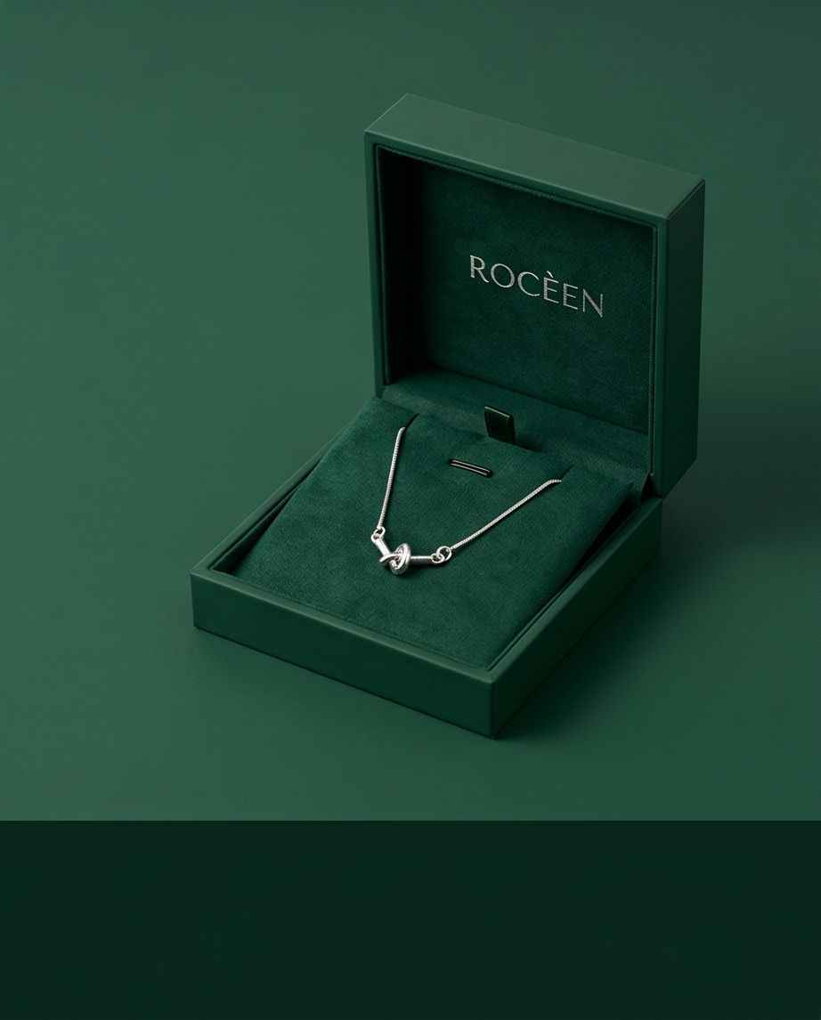 Silver knot pendant necklace in open gift box with chain and clasp