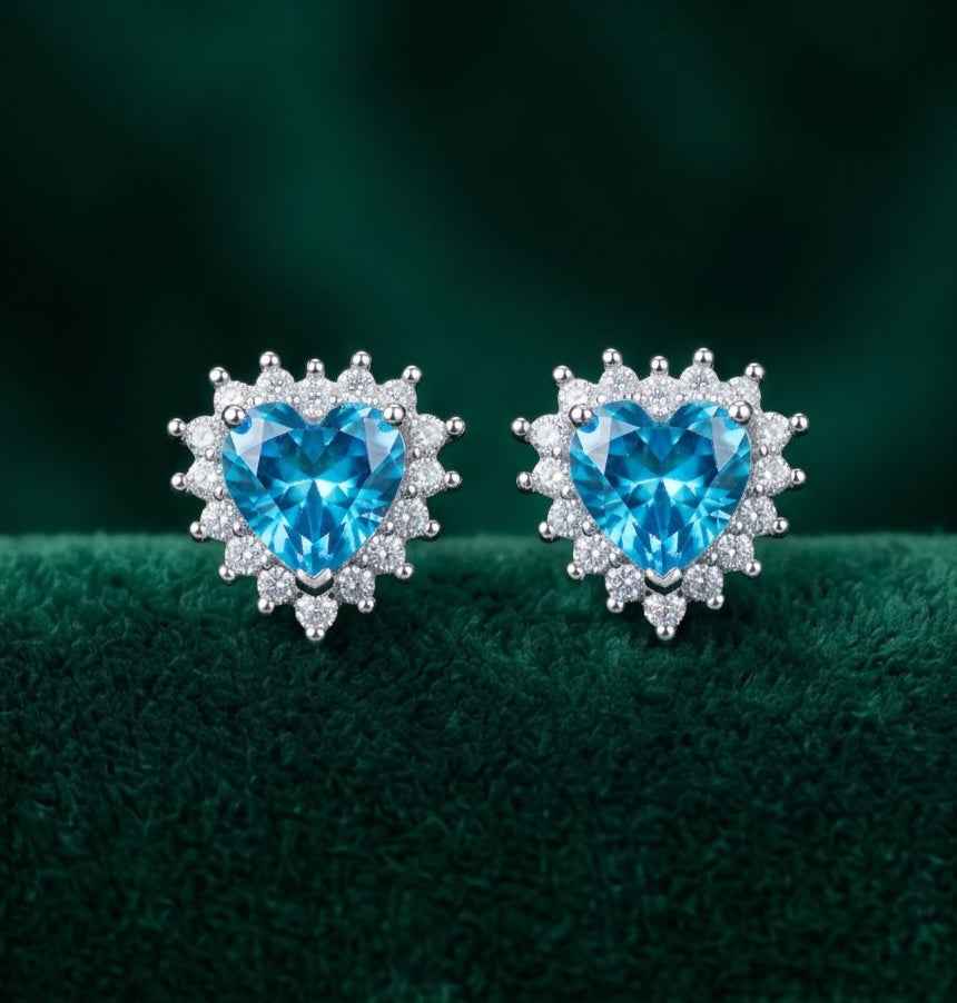 Pair of blue heart halo stud earrings, silver-tone settings with clear stone halos