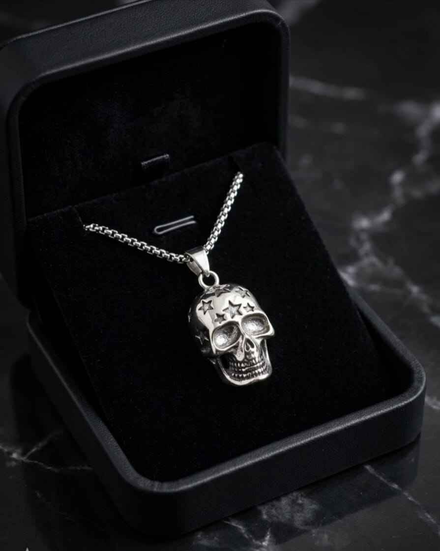 Skull pendant necklace with star details and silver chain in black jewelry box