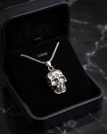 Skull pendant necklace with star details and silver chain in black jewelry box