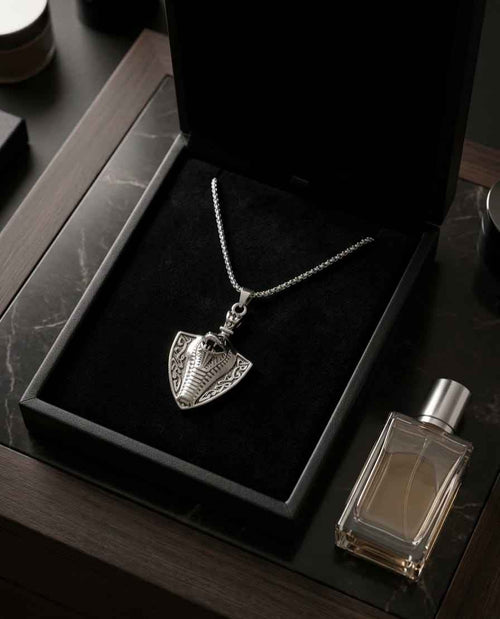 Shield pendant necklace with silver-tone chain and engraved shield charm