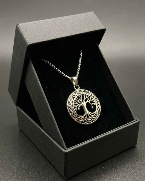 Silver-toned tree-of-life medallion pendant necklace on chain, shown in dark box