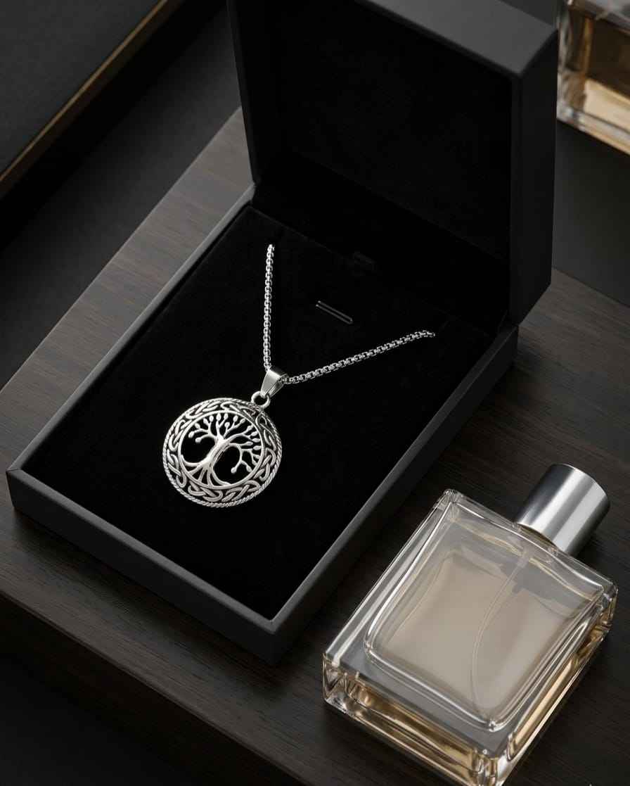 Silver-toned round medallion necklace with tree-of-life design and chain in black box