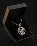 Silver Celtic knot necklace with round pendant featuring trinity knot and chain in box