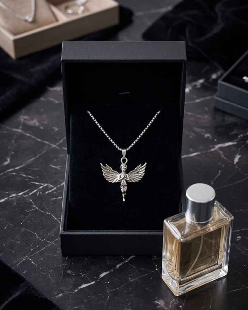 Silver angel pendant necklace with wings and cherub charm centered on a chain