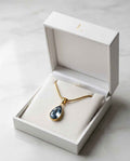 Teardrop blue gemstone necklace with gold chain in white gift box