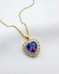 Gold-tone heart pendant necklace with blue sapphire-style crystal and clear accents