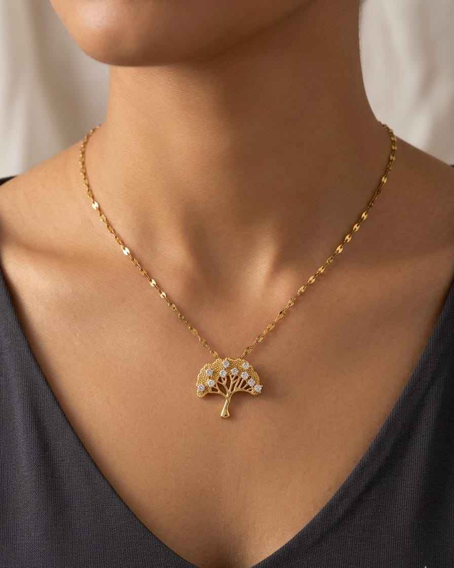 Gold-tone necklace with tree pendant set in round crystal clusters on chain