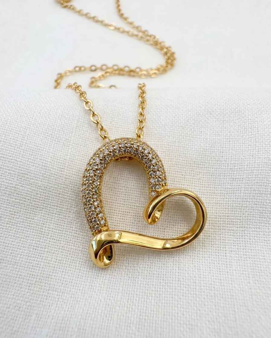 Gold-tone pavé heart-shaped pendant necklace on a chain, close-up