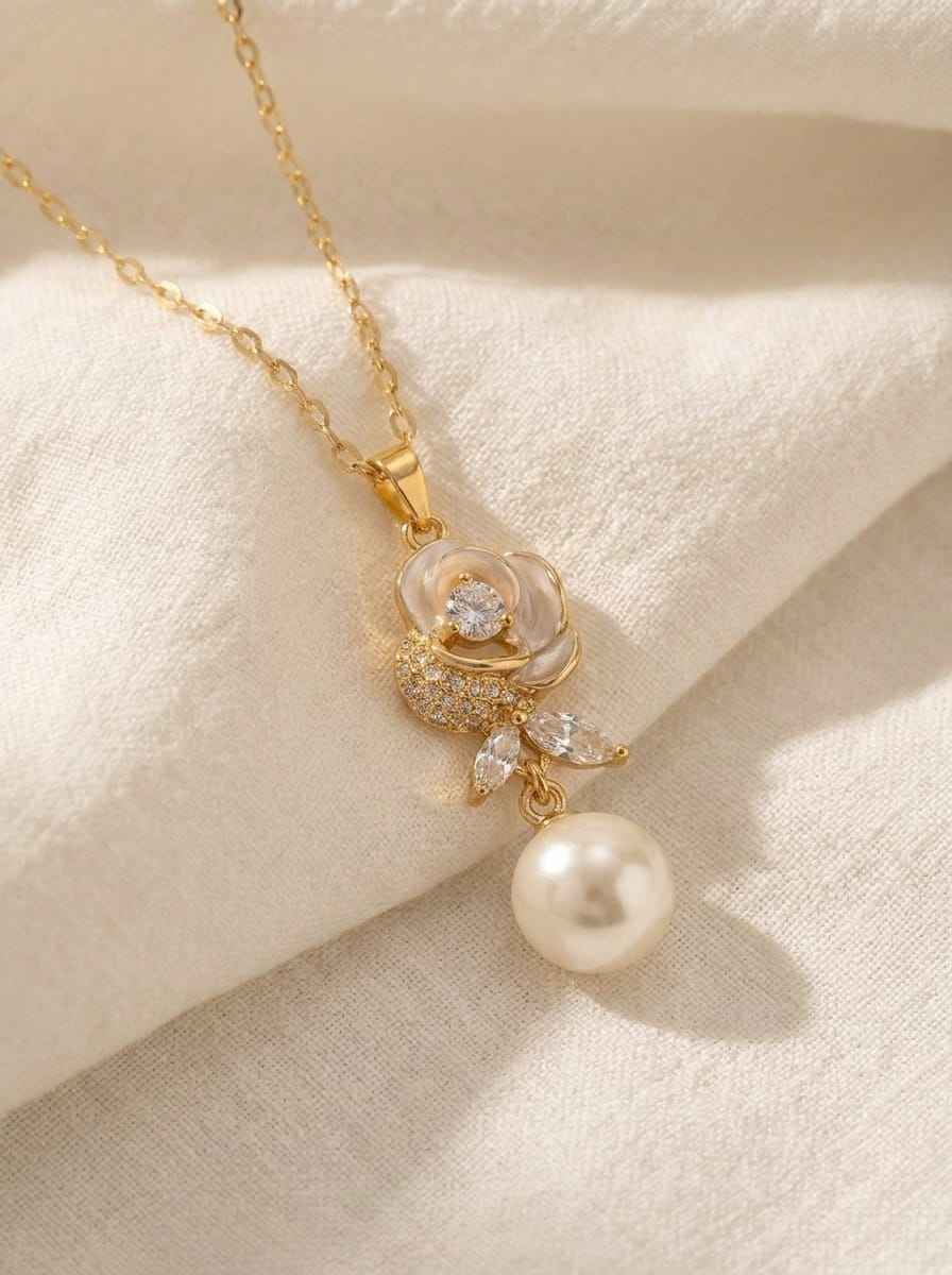 Gold-tone bloom necklace with pearl drop and crystal flower pendant