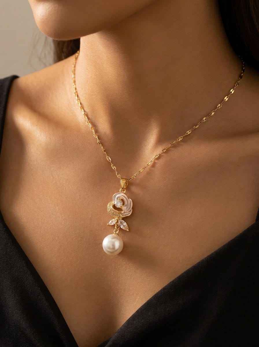 Gold-tone bloom necklace on model, pearl drop with crystal flower charm
