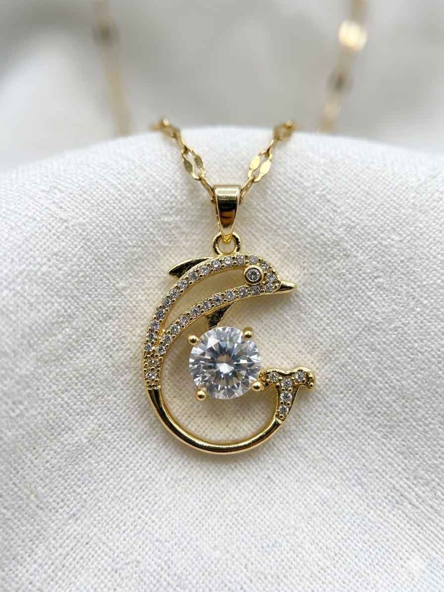 Gold-tone crescent pendant necklace with large clear crystal and pavé accents