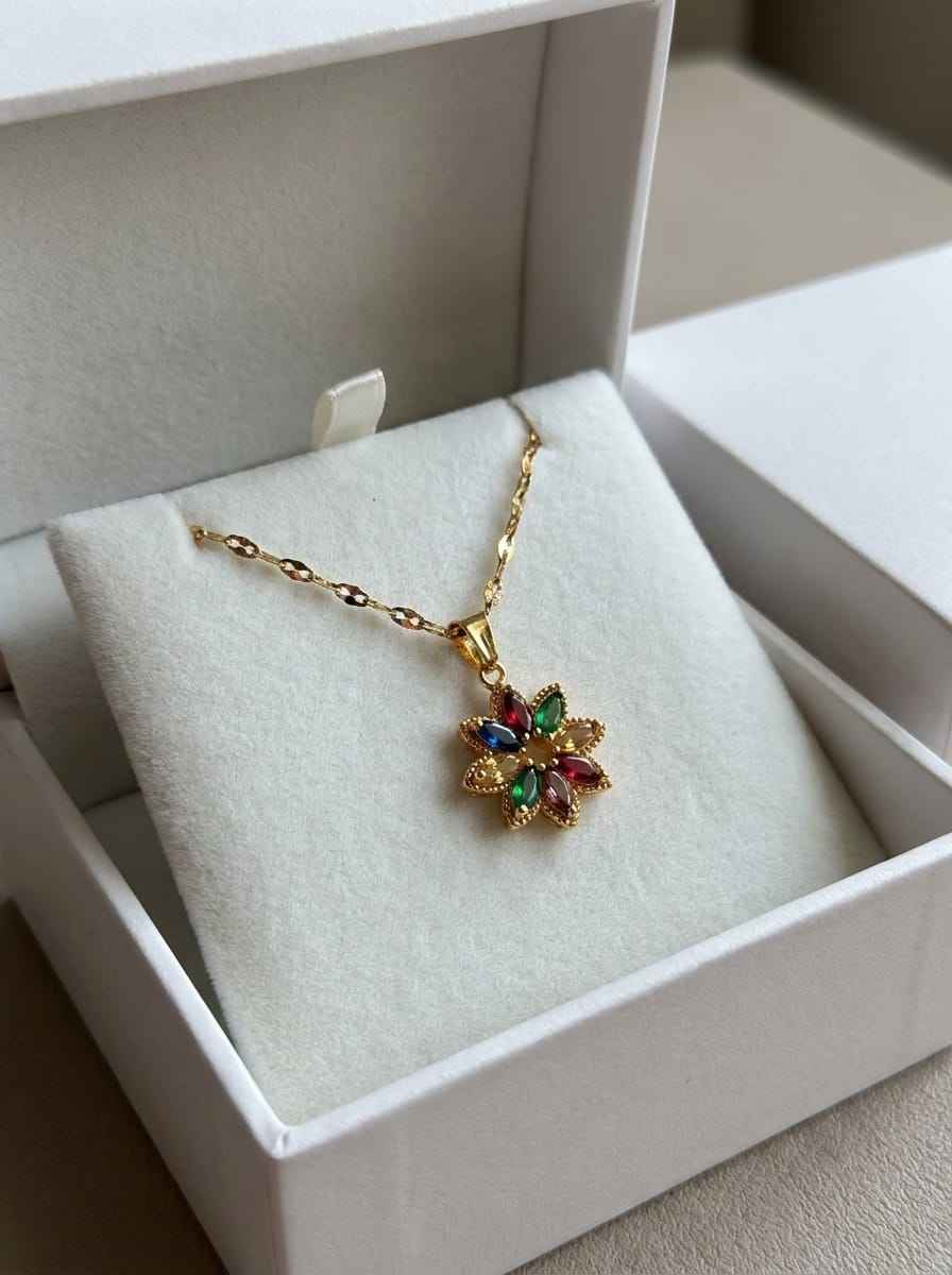 Gold crystal flower pendant necklace displayed in a gift box with chain and clasp