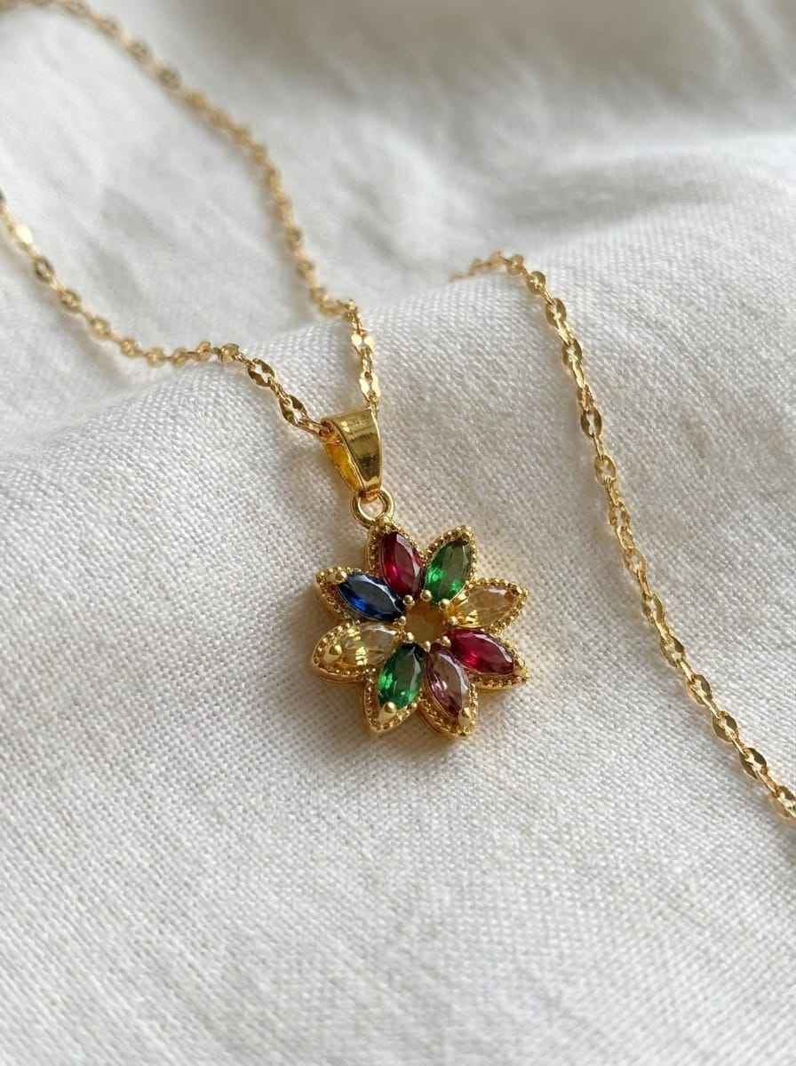 Gold pendant necklace featuring a multicolor crystal flower and link chain