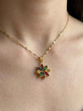 Gold crystal flower pendant necklace with multicolor gemstone petals on a chain