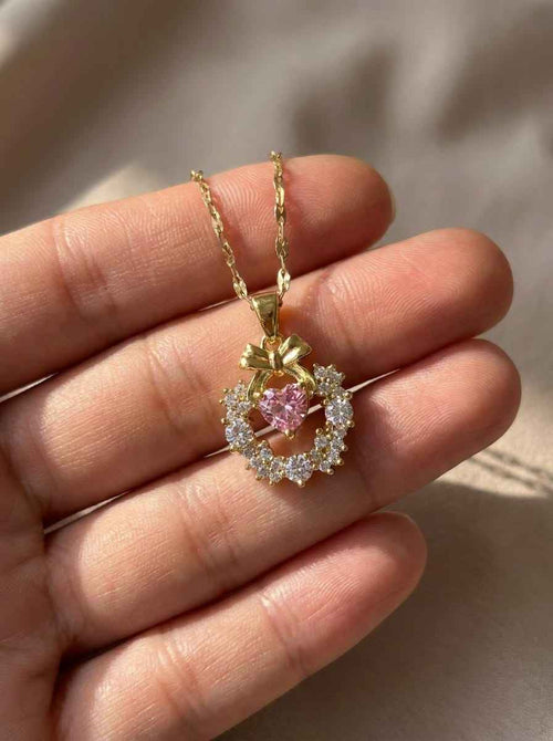 Gold-tone necklace with pink halo gemstone pendant and slim chain
