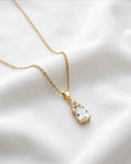 Gold teardrop pendant necklace with clear stone and sparkle halo