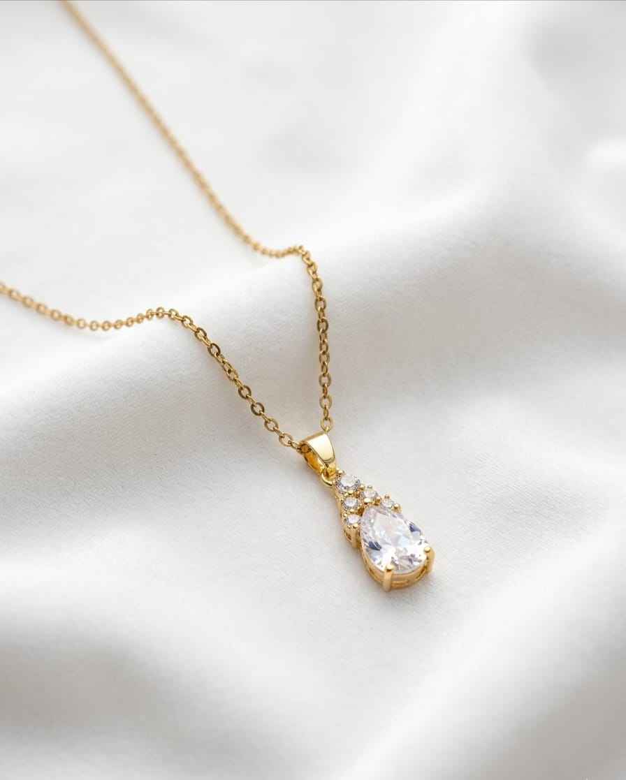 Gold teardrop pendant necklace with clear stone and sparkle halo