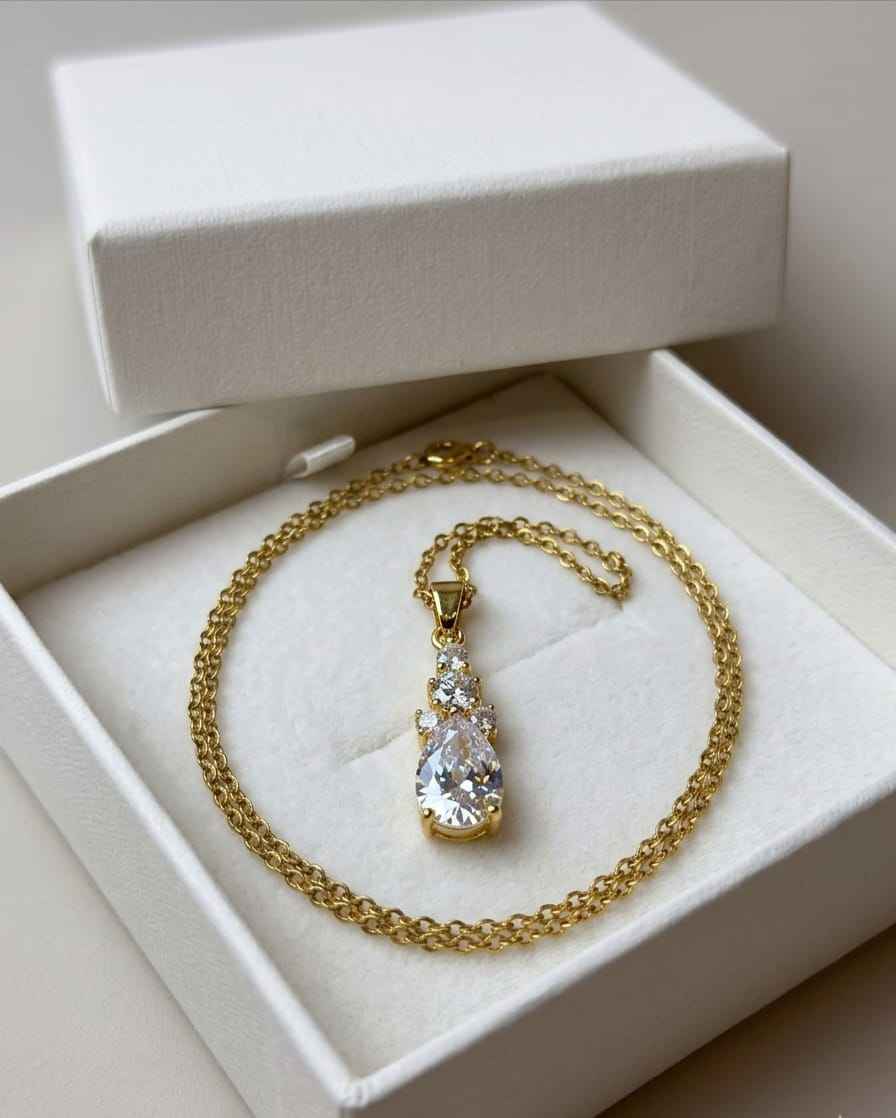 Gold-tone teardrop pendant necklace in gift box, clear stone with pavé details
