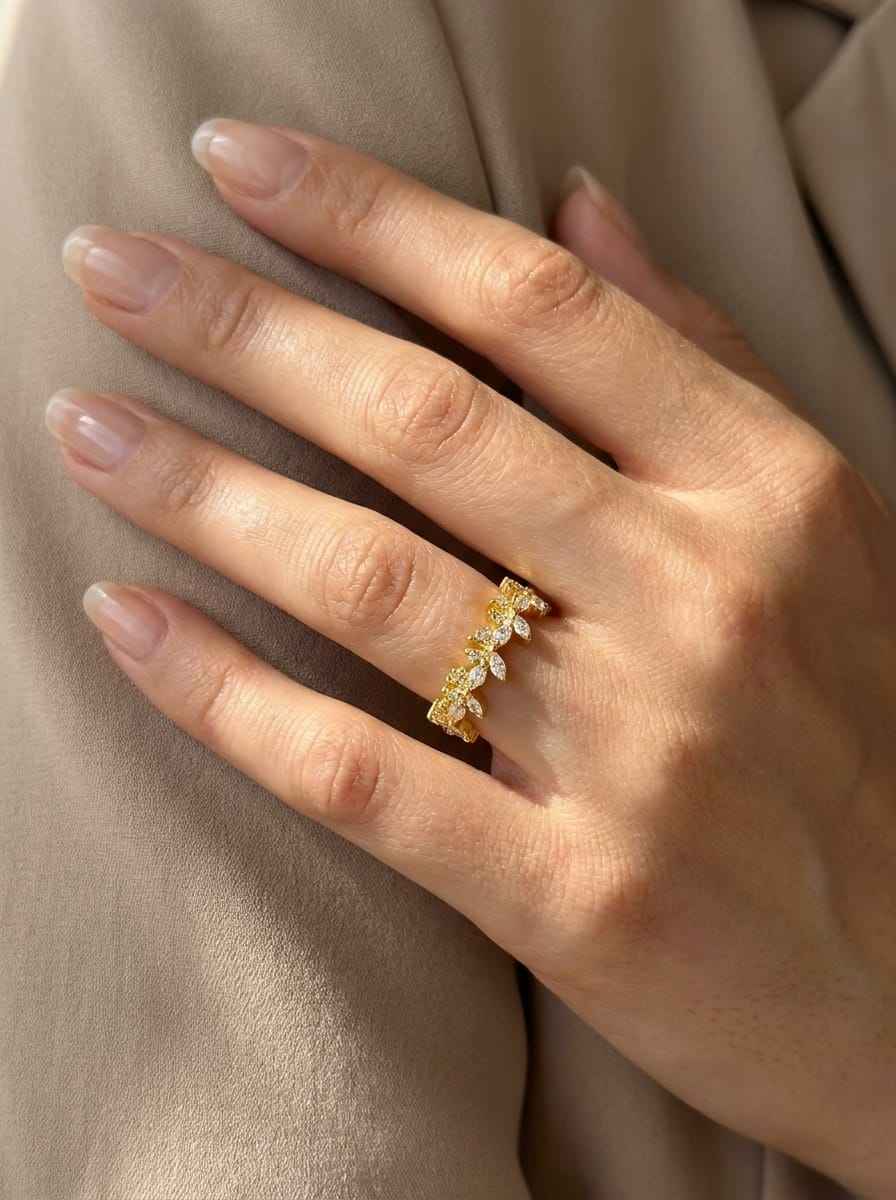 Gold diamond bloom ring with marquise stones, worn on finger, floral design