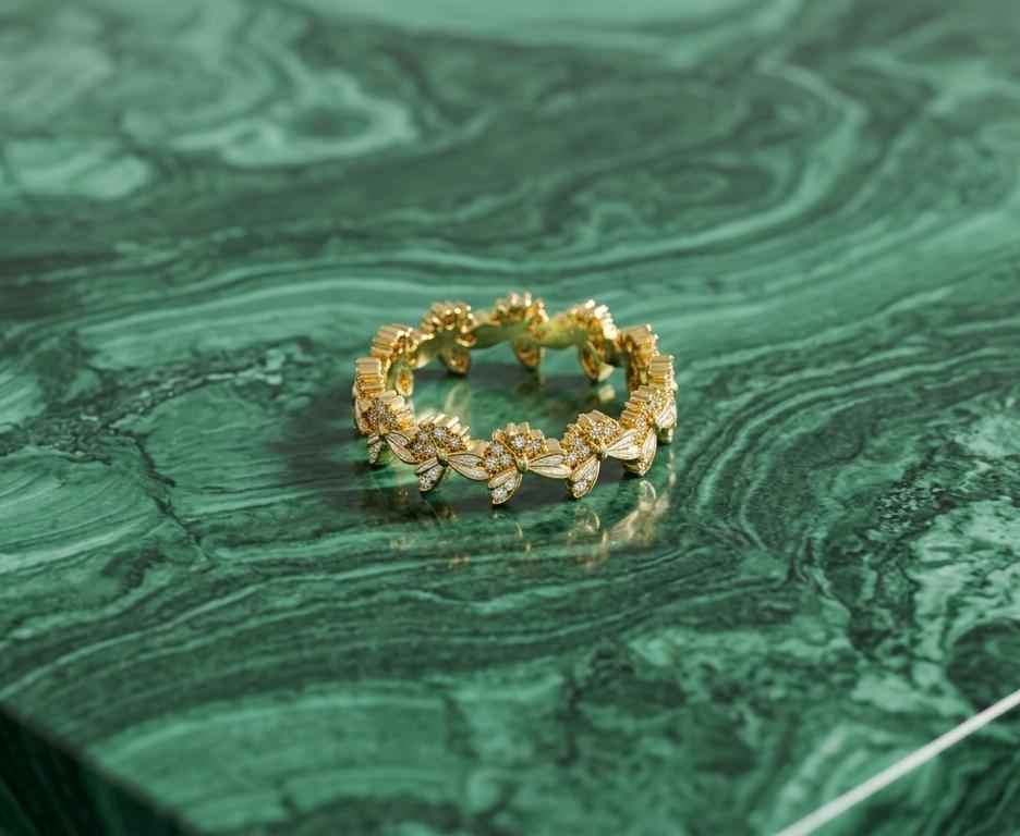 Gold diamond bloom ring with repeating floral marquise stones, circular band view