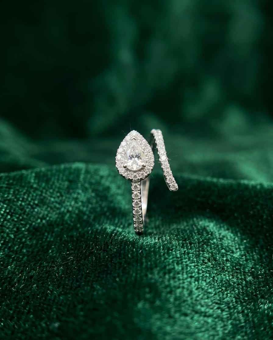 Teardrop pavé ring with round center stone and slender split shank
