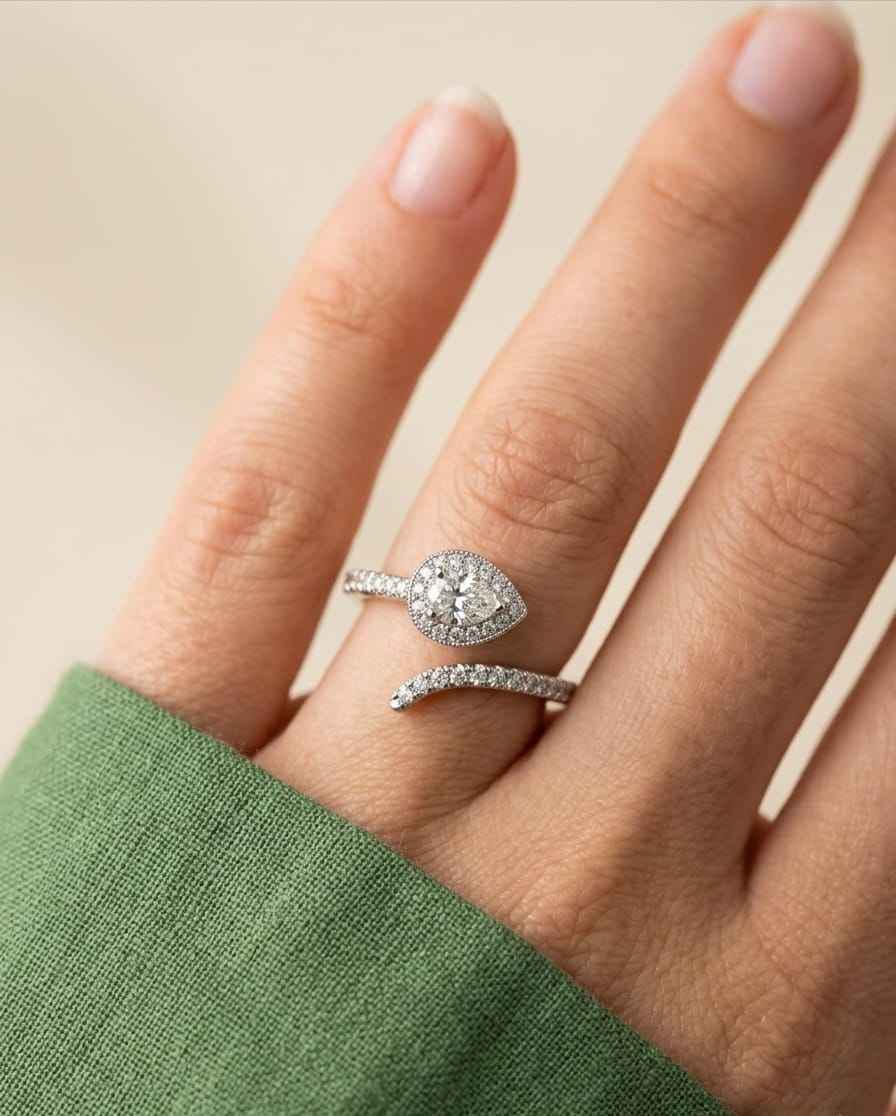 Teardrop pavé ring and curved pavé band on a hand